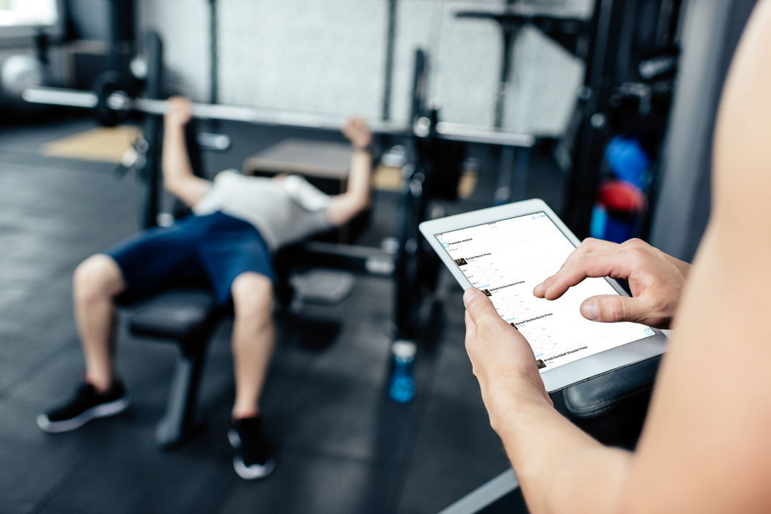 Personal trainer using Trainerize with an in-person client